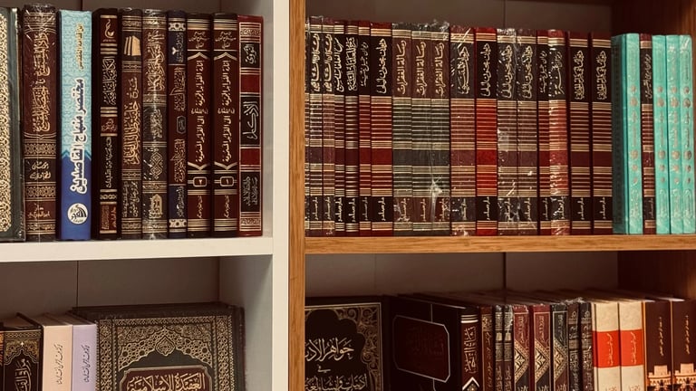 Multiple shelves displaying a collection of leather-bound books in various colors including brown, red, and green